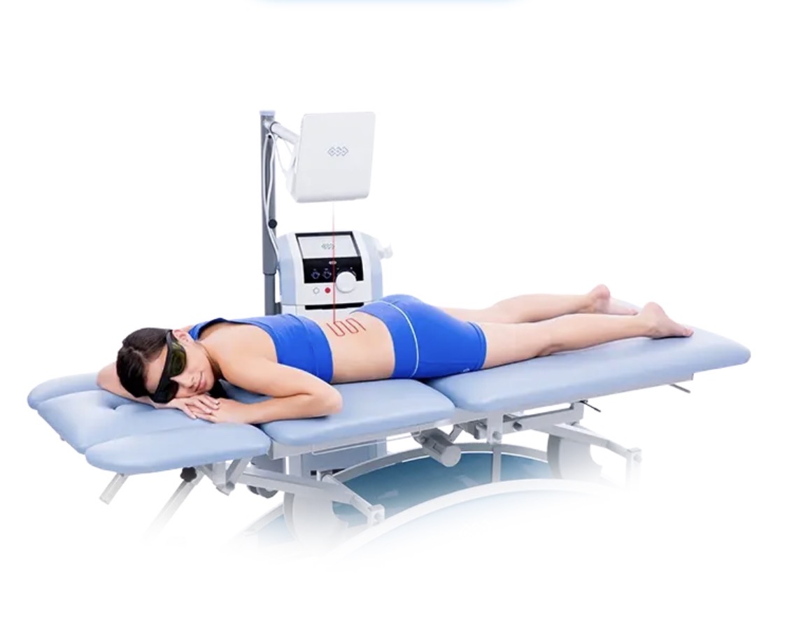 Woman beneath the HILT robotic laser head during therapeutic scanning